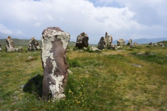 Stone pillars in a natural meadow under a blue sky, stone circle, megaliths, Zorats Karer,