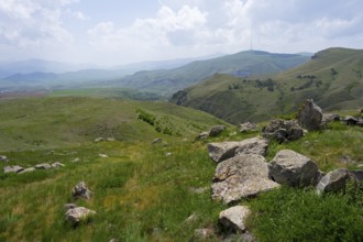 View of a hilly landscape with scattered stones and a wide panorama, landscape near Zorats Karer,