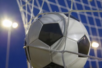 Soccer symbol: close-up of a soccer ball under floodlights