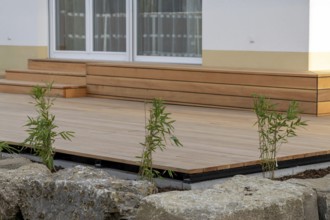 Beautiful wooden terrace on a newly landscaped garden