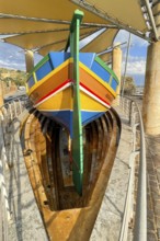 Monument to traditional fishing boats abandoned jacked up typical colorful painted old fishing boat