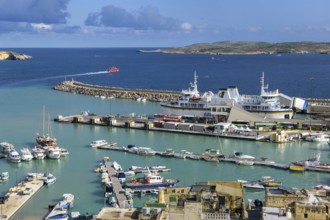 View from an elevated position of Mgarr harbour on the island of Gozo, large car ferry with open
