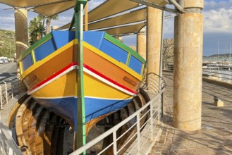 Monument to traditional fishing boats abandoned jacked up typical colorful painted old fishing boat