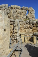 View from secured walkway with railing through ruins remains of Ggantija temple, UNESCO World
