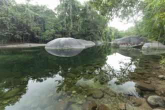 Turquoise blue water between rocks in the Babinda Boulders tropical rainforest in Queensland,