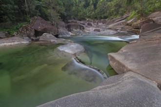 Turquoise blue water between rocks in the tropical rainforest of Babinda Boulders Queensland
