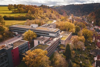Autumn drone view of a building complex surrounded by forest and nature, Calw District Office,