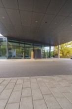 Flat roof building with glass façade and large entrance under covered area, Calw District Office,