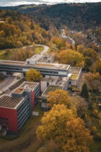 Large building seen from above, surrounded by forest and roads, Calw District Office, Calw, Germany