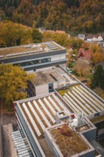 Building complex from above with a detailed roof and autumn surroundings, Calw District Office,