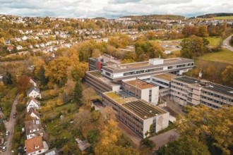 Building complex in autumn surroundings, aerial view with city view, Calw District Office, Calw,