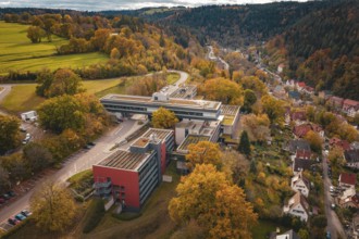 Aerial view of a large building in an autumn landscape with roads, Calw District Office, Calw,