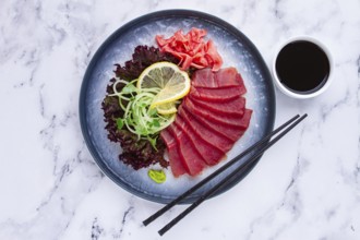 Tuna sashimi, with side dish, on a marble table, homemade, no people