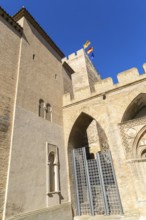 Looking up at historic tower and ramparts in courtyard of historic castle, Aljafería Palace,