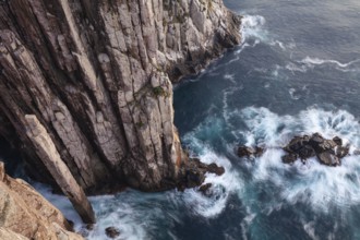 Totem Pole Long exposure at sunrise shows glowing dawn over the dramatic cliffs of Cape Hauy. Waves
