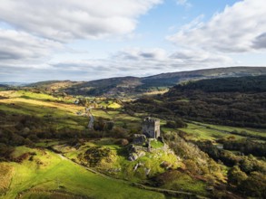 Autumn colours over Castell Dolwyddelan and Eryri Mountains from a drone, Snowdonia, Conwy County