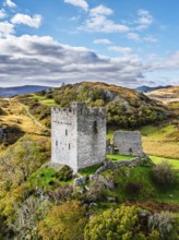 Autumn colours over Castell Dolwyddelan and Eryri Mountains from a drone, Snowdonia, Conwy County