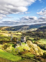 DefAutumn colours over Castell Dolwyddelan and Eryri Mountains from a drone, Snowdonia, Conwy
