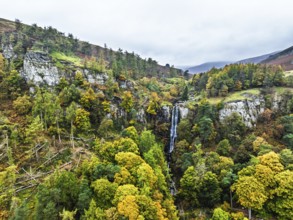 Autumn colours over Pistyll Rhaeadr Waterfall and Berwyn Mountains from a drone, Oswestry,