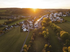Village surrounded by trees with warm autumn atmosphere at sunset, Deufringen, Aidlingen, Böblingen