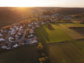 Wide view of a village on a sunny autumn evening with fields and hills, Deufringen, Aidlingen,