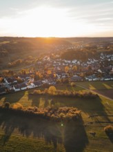 View of a village at dusk surrounded by autumnal fields, Deufringen, Aidlingen, Böblingen district,