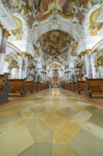 Magnificent baroque church corridor with artfully painted ceiling and decorative benches, ZFP
