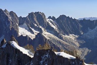 Rugged rocks jut out of a snow-covered mountain, viewing platform, Aiguille du Midi mountain