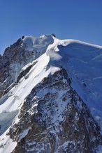 A group of mountaineers runs across a snow-covered mountain, Aiguille du Midi, Chamonix-Mont-Blanc,