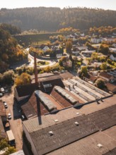 Aerial view of an industrial site in autumn with old buildings and trees, Nagold, Black Forest,