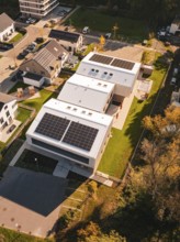 Aerial view of a Kita Hasenbrunnen building with solar panels in a residential area, Nagold, Black