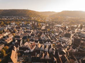 Aerial view of a city with historic roofs and autumn trees, Nagold, Black Forest, Germany