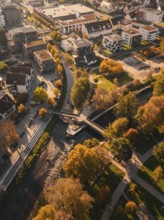 Aerial view of a bridge and a river in an autumnal town, Nagold, Black Forest, Germany