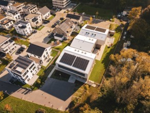 Aerial view of a modern residential area Kita Hasenbrunnen with solar panels and autumn