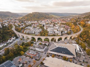 Aerial view of a city with a viaduct surrounded by autumn landscape, Nagold, Black Forest, Germany