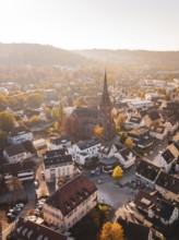 Center of a city with a church and autumn trees from the air, Nagold, Black Forest, Germany