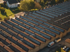 Industrial roof structure with a delivery vehicle in an autumn light, seen from the air, Nagold,