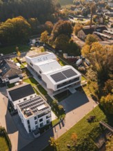 Aerial view of a modern settlement with solar panels in autumn light, Nagold, Black Forest, Germany