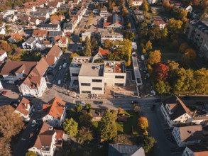 Urban aerial view with autumn trees and winding roads in the sun, Nagold, Black Forest, Germany