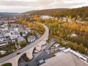 Aerial view of a city with a bridge across a valley and autumn trees along the hills, Nagold, Black
