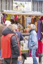 People in front of a market stand selling clothes and accessories, Streuobstmarkt, Sindelfingen,