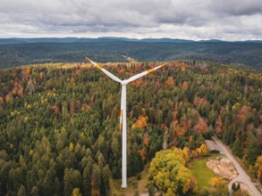 Wind turbines in autumn forest surrounded by clouds and roads, Simmersfeld wind farm, Germany