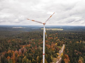 Wind turbine above a forest in autumn colors, with a wide view, Simmersfeld wind farm, Germany