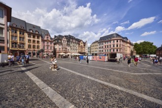 Square made of paving stones and marble slabs with pattern, row of houses, reconstructed historic
