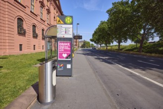 Landtag bus stop, New Armoury, historic building, public trash can, lantern, trees, lawn, blue sky,