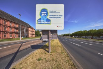Welcome to Gutenberg City, tourist sign, roads, lanes, central island, lantern, trees, lawn, blue