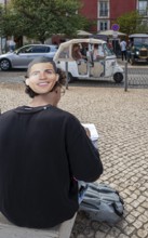 Street art, young people with Ronaldo mask on the back of their heads taking part in a school