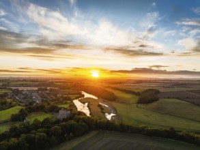 Sunset over Norham Castle and River Tweed from a drone, Norham, Northumberland, England, United