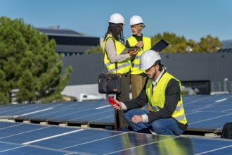 Team of solar energy engineers and technicians performing a routine inspection, checking