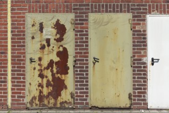 Metal doors on an industrial building, rusty and new, Düsseldorf, North Rhine-Westphalia, Germany